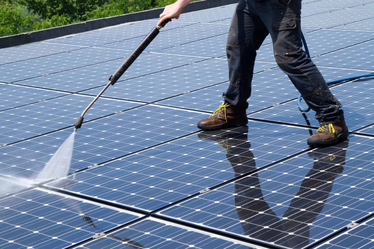 Professional-cleaning-solar-panels-on-roof